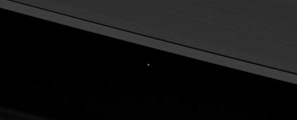 This photo of Earth peeking through Saturn's rings is giving us all the feels