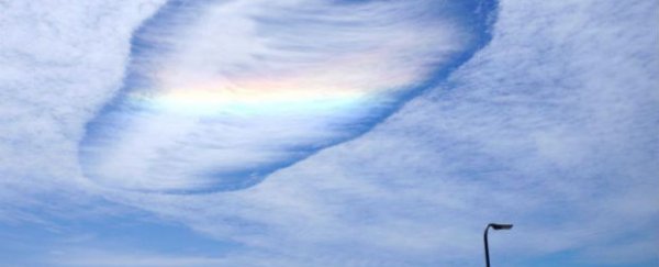 Shimmering rainbow cloud forms in Australian sky