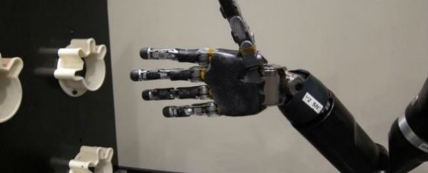 WATCH: New mind-controlled robot arm grabs and moves objects