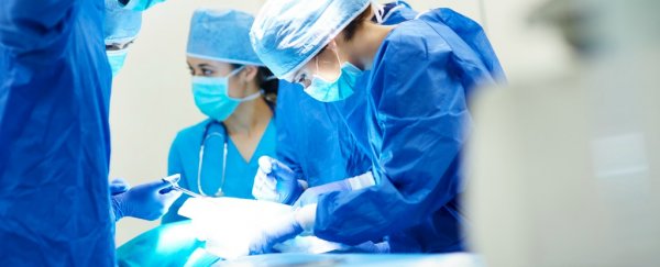 A renowned surgeon has pleaded guilty to burning initials onto patients' organs